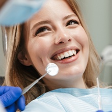 woman smiling up at dentist