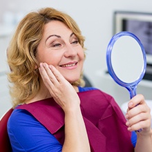 woman checking smile in circle mirror