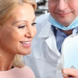 Dentist showing woman patient smile