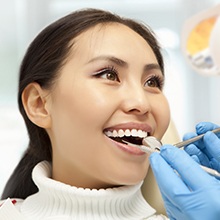 woman with white smile having teeth checked