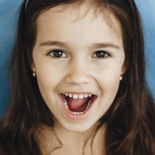 young girl smiling with mouth open