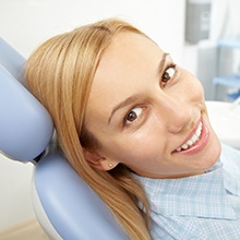 woman looking over shoulder and smiling